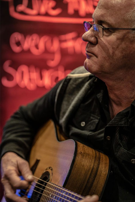 Live performer playing the guitar